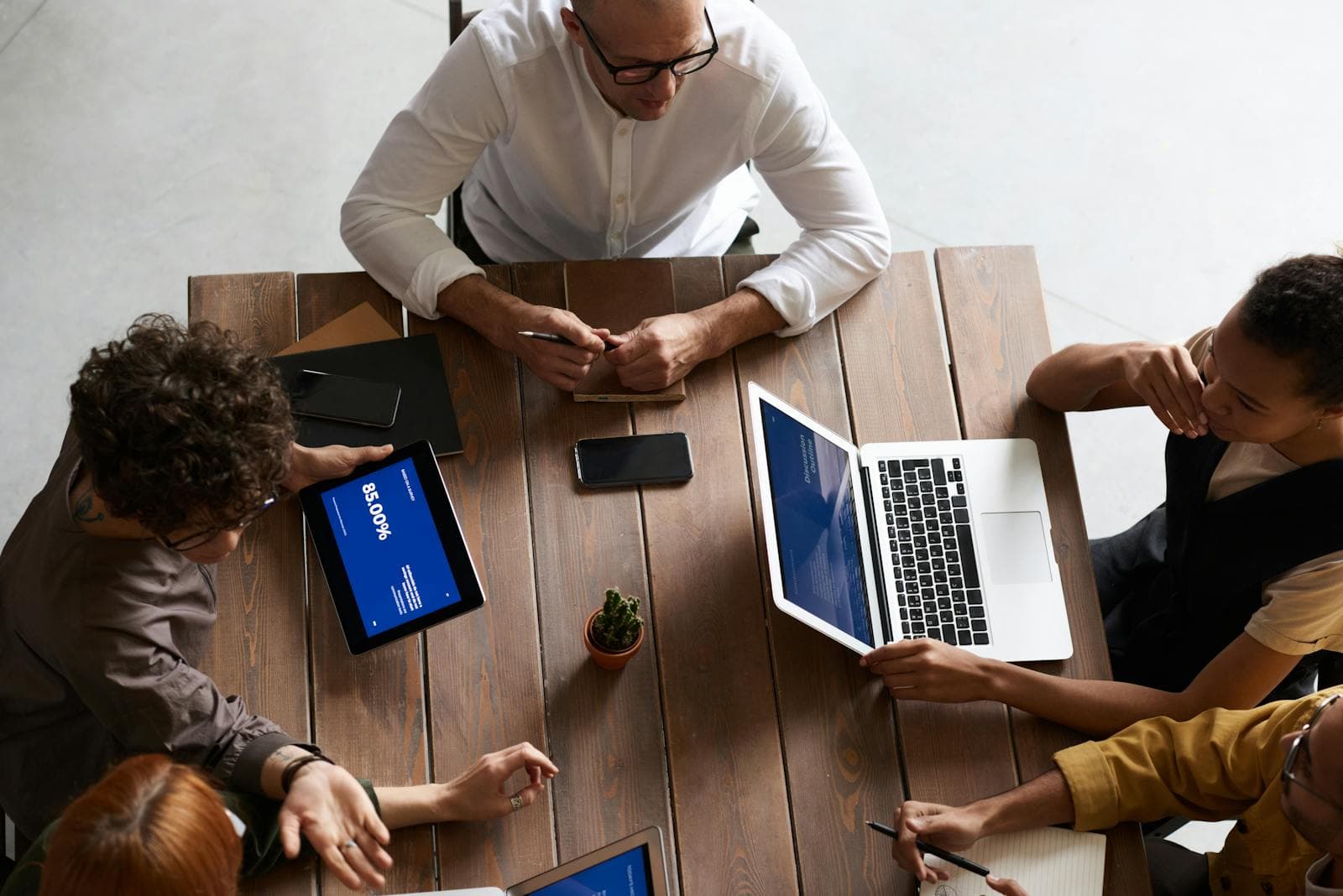 A premium business workspace with laptop, notes, and strategic planning materials.
